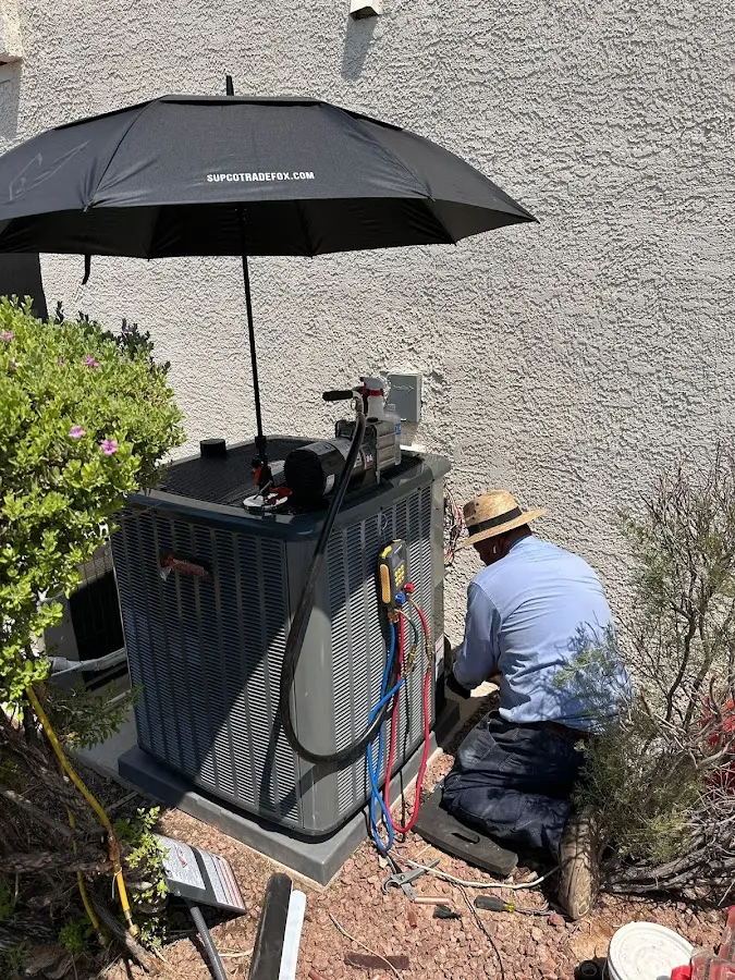 HVAC technician performing outdoor AC maintenance in Antigo
